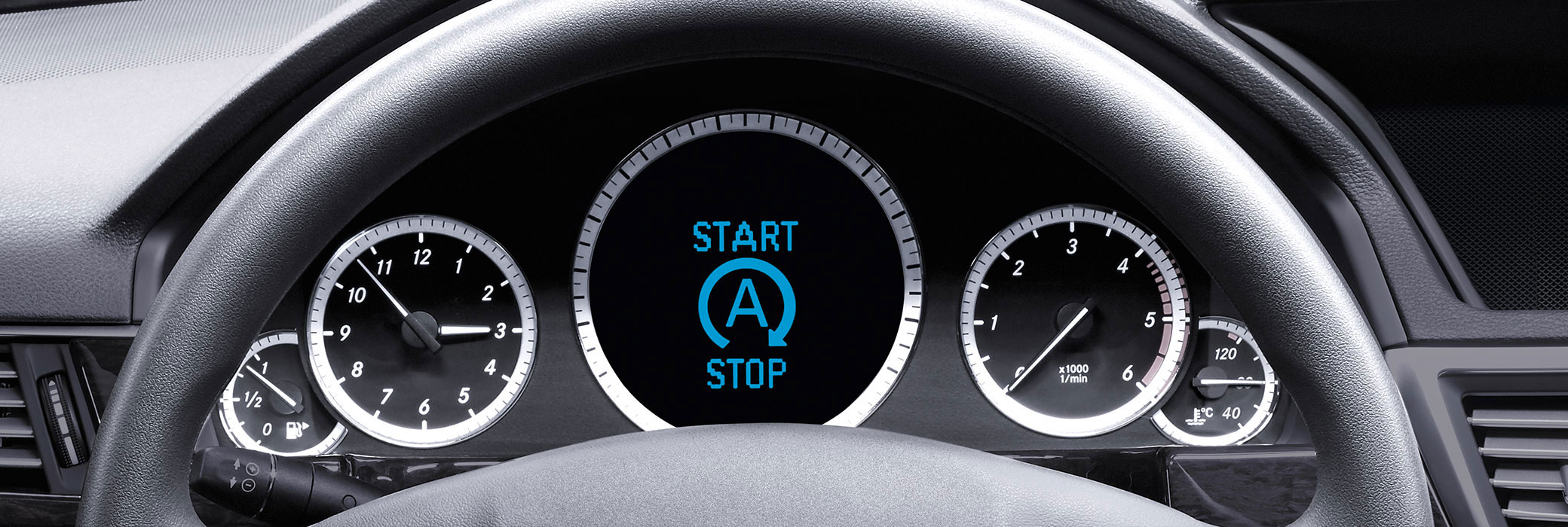 Car Dashboard behind Steering Wheel
